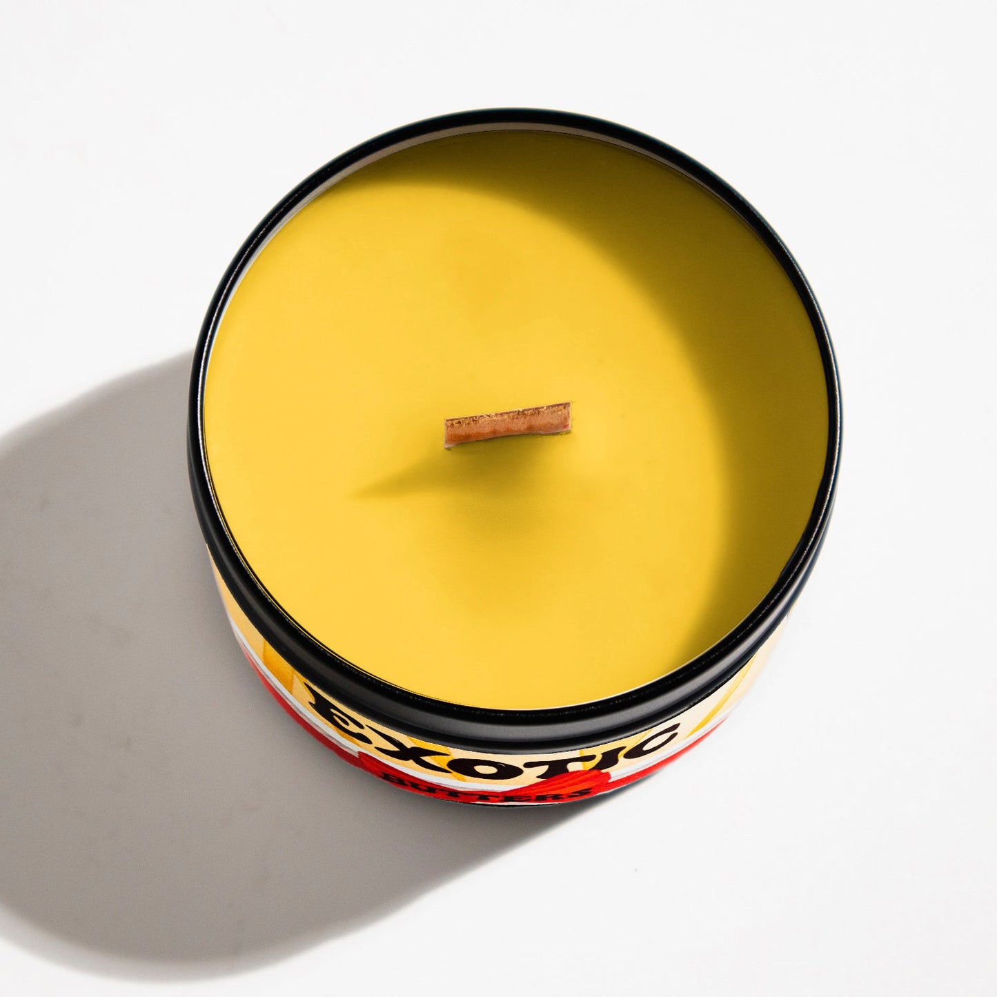 Exotic Butters candle with a smooth butter and salt scent, hand-poured as a playful nod to late-night shifts and oddly specific gifts.