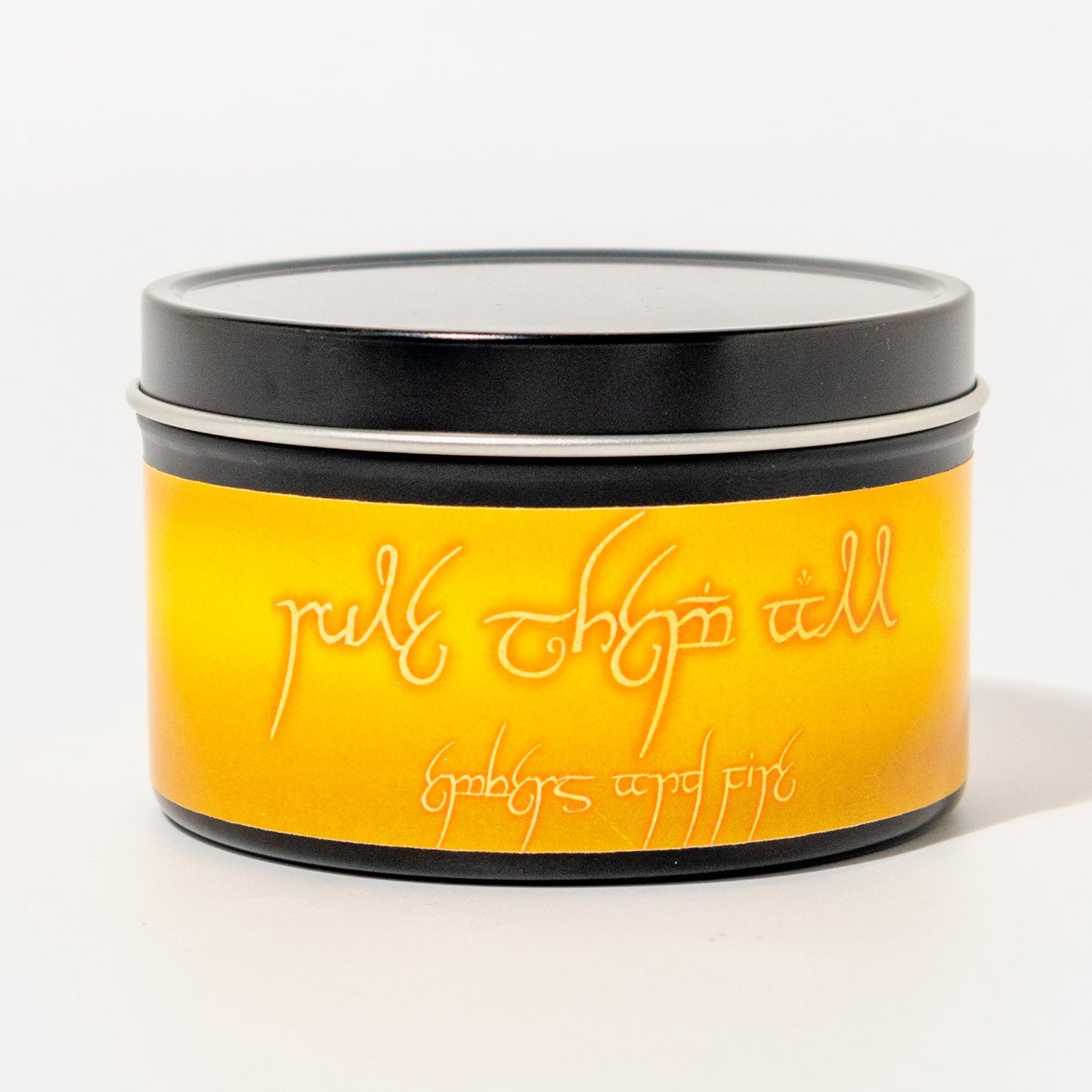 Hand-poured soy candle named Rule Them All with embers and fire scent, inspired by fantasy adventure